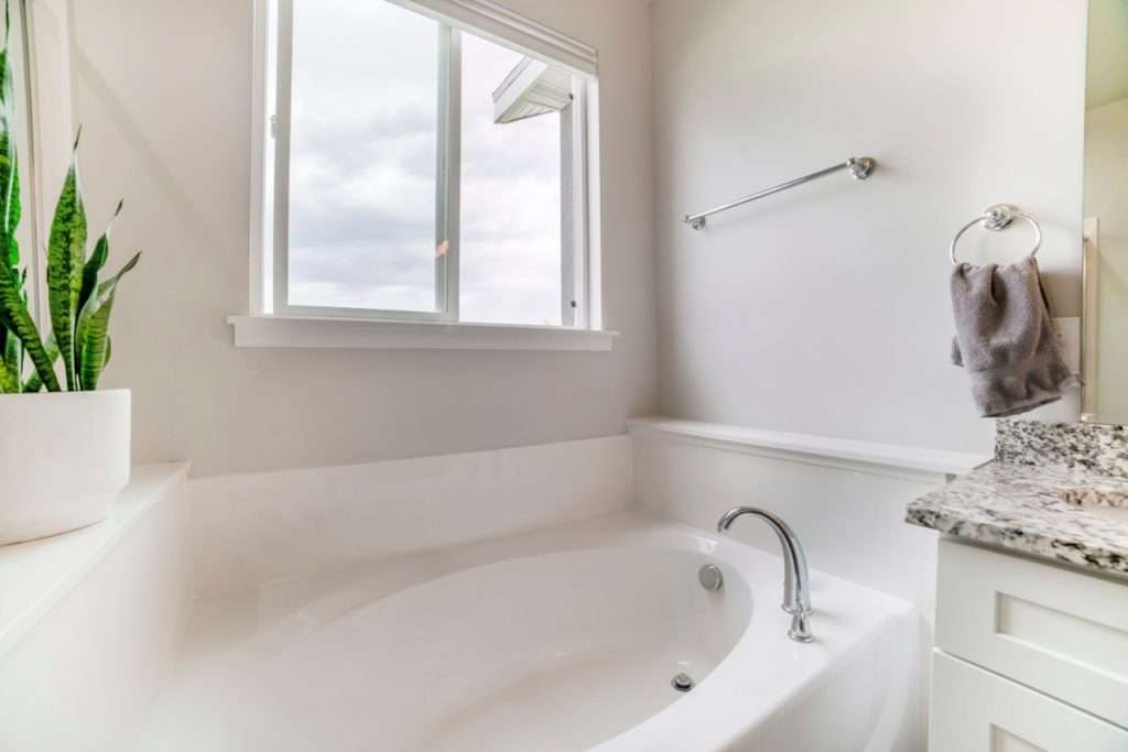 White Bathroom Interior With Potted Snake Plants And Sliding Window professional sliding windows installation and replacement - 8