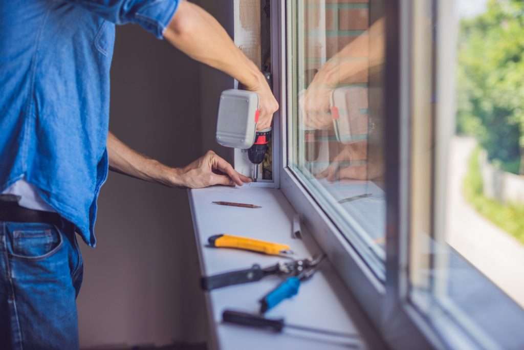 Man,In,A,Blue,Shirt,Does,Window,Installation. about - 10