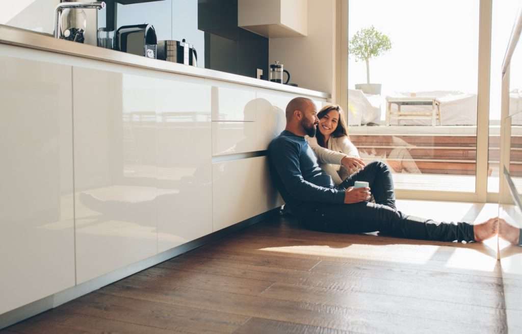 Young,Man,And,Woman,Sitting,On,Floor,In,Kitchen,And about - 9