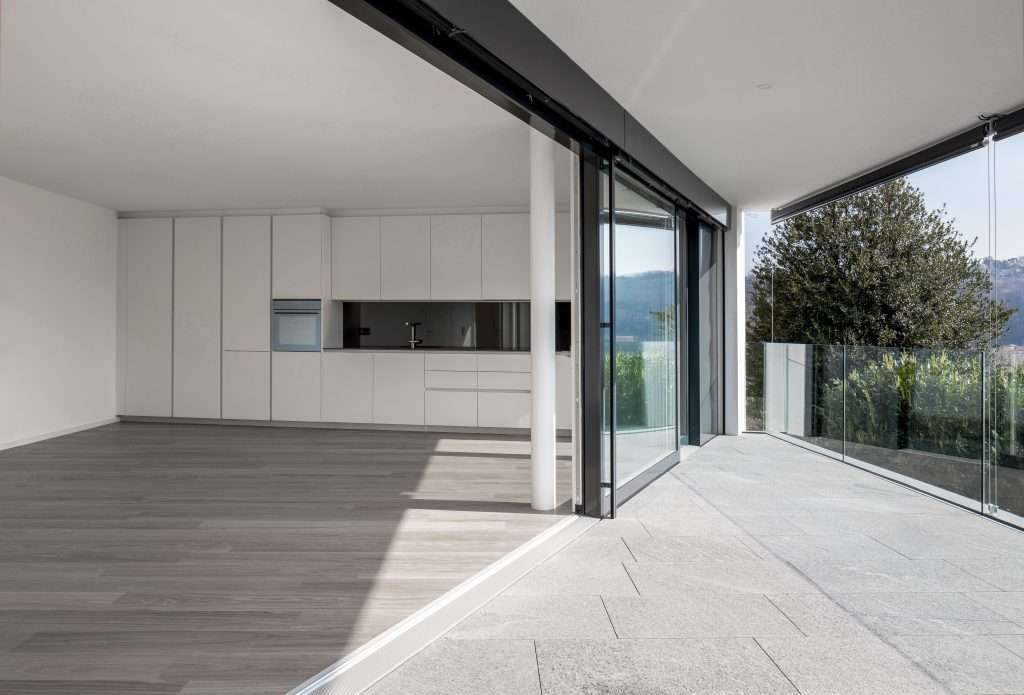 Inside A Large Space, A Studio With A Kitchen And A Large Window expert sliding doors installation and repair services - 7